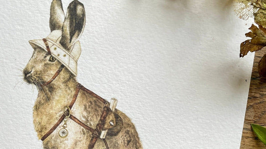 Illustration of a rabbit on a white card with dried plants and leaves around